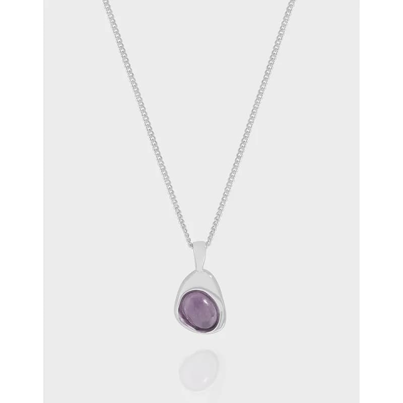 Silver chain necklace with a drop-shaped pendant holding a purple oval stone in a bezel setting.
