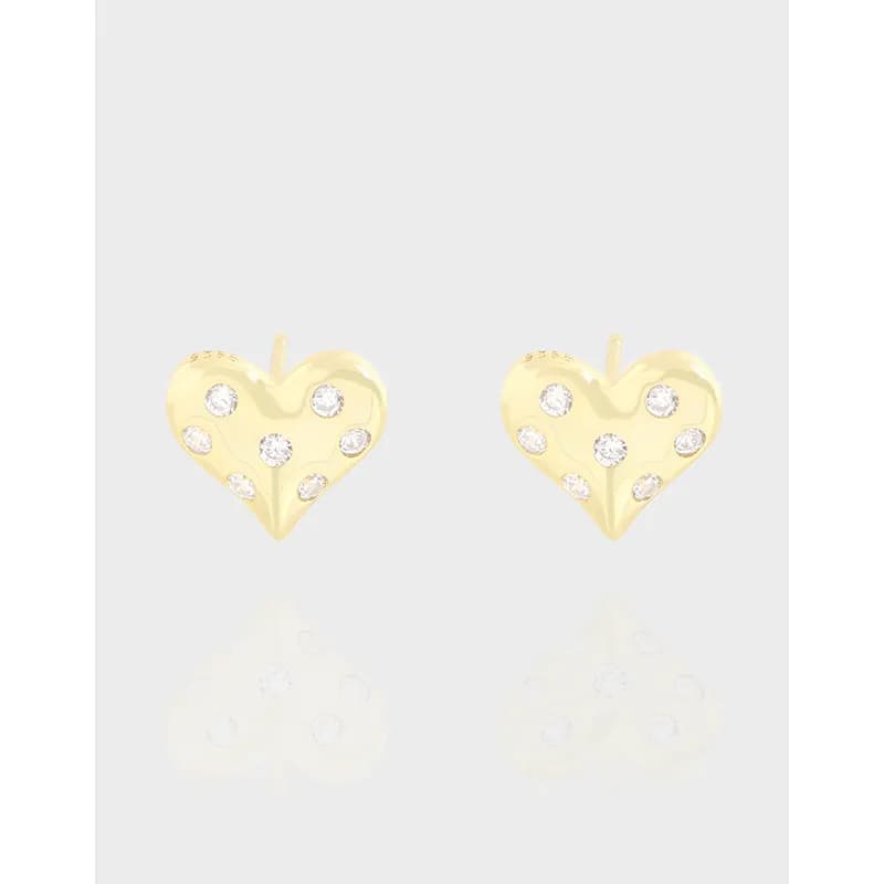 Two polished sterling silver heart-shaped stud earrings with stones on a light background.