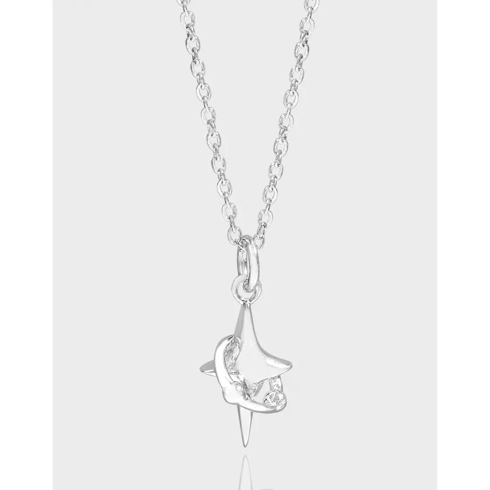 Sterling silver star pendant hanging from a simple linked chain against a light background.