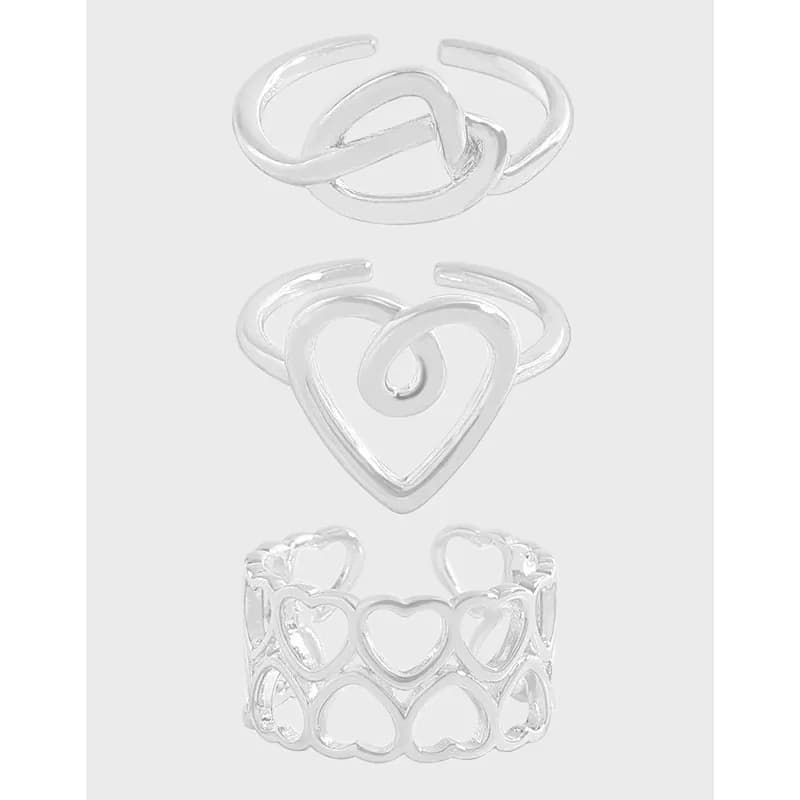 Vertical image of three silver pieces: a knot ring at the top, a heart outline ring in the middle, and a heart lattice bracelet below.