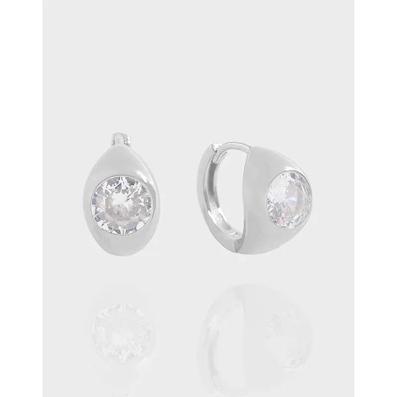 Sterling silver teardrop earrings with a bezel-set round stone
