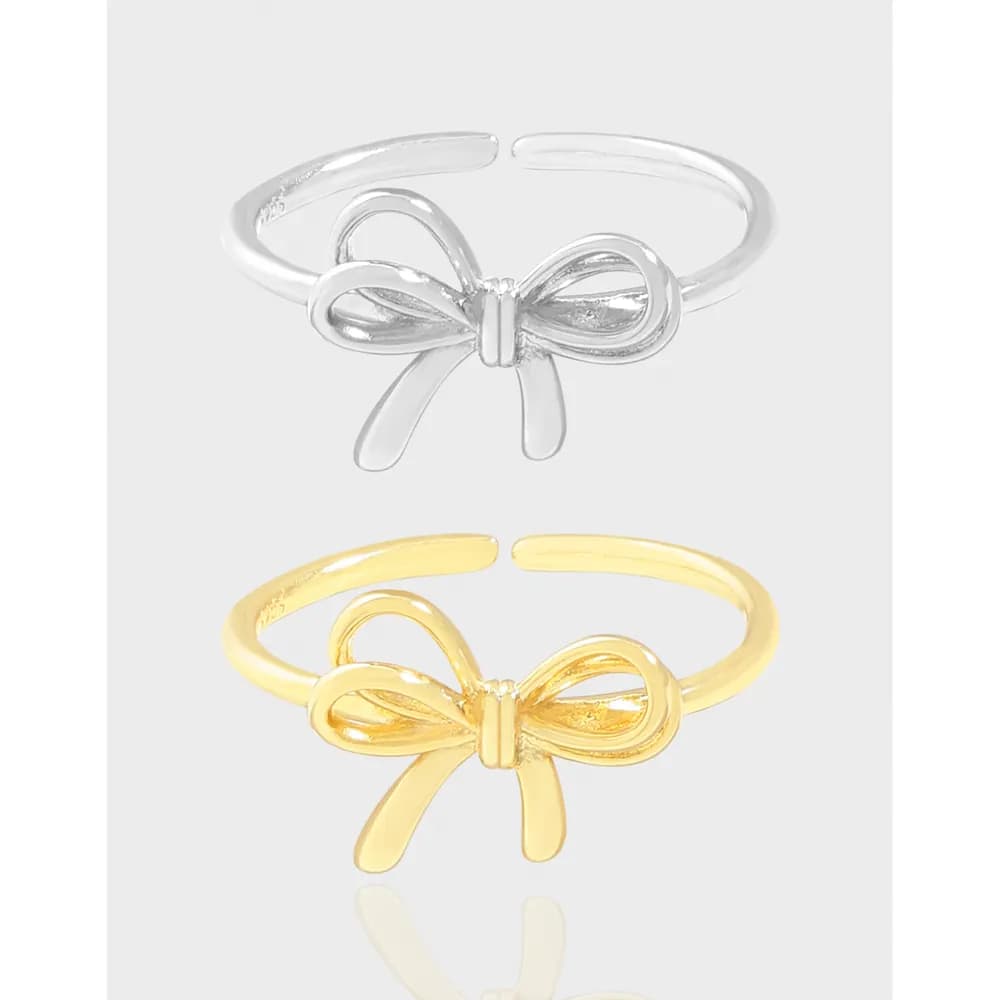 Slim sterling silver ring with a front bow motif and an open, adjustable band.