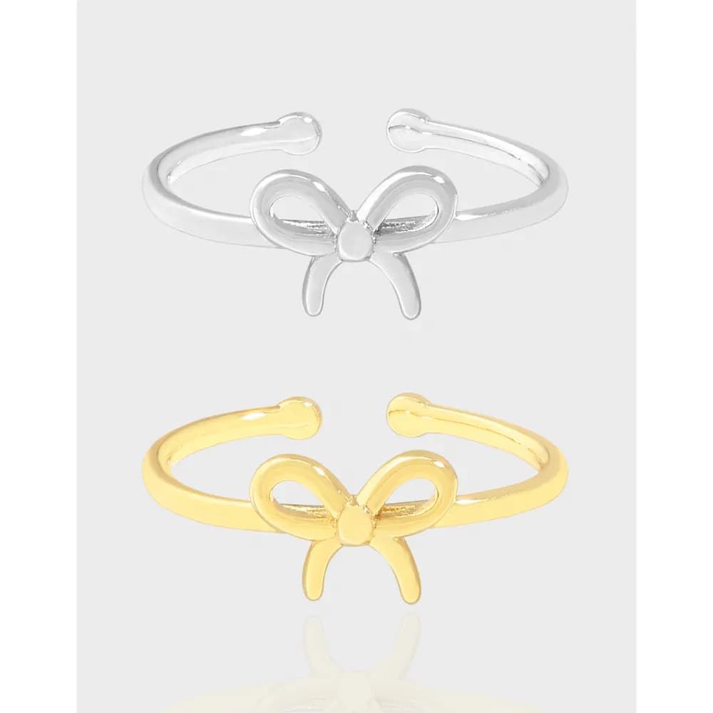 Open-bow ring with a slim band available in silver and gold-tone finishes.