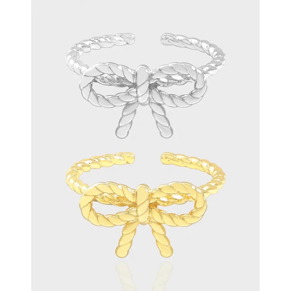 Open-ended rope bow ring with a twisted rope band in silver and gold tones.