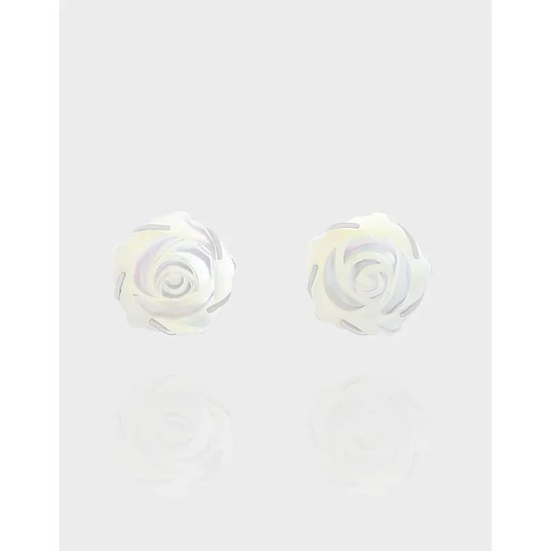 Polished sterling silver rose petal stud earrings on a pale background.