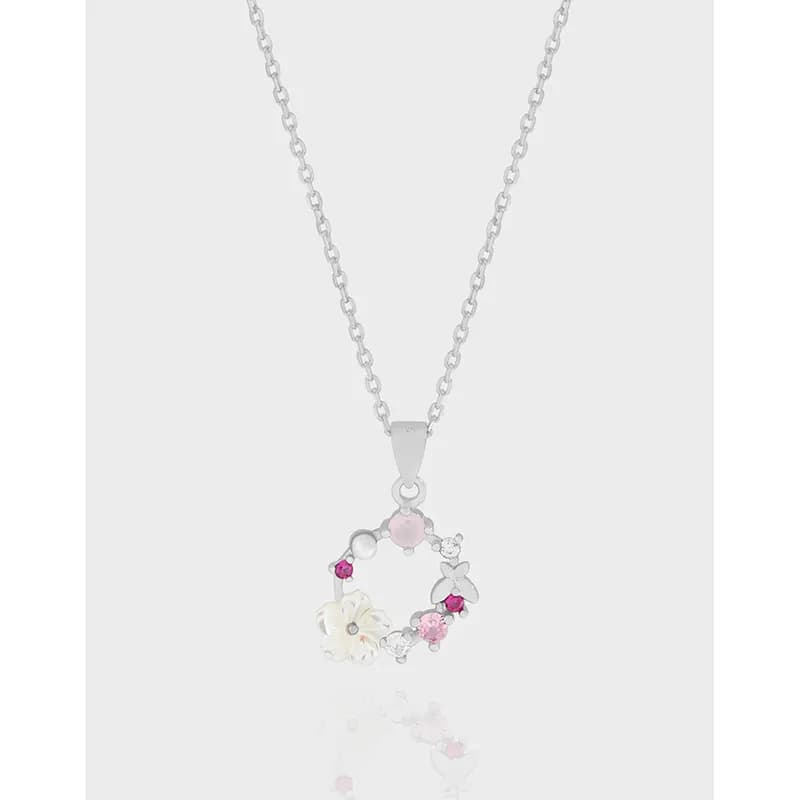 Sterling silver necklace with a circular floral pendant featuring pastel stones and crystal accents.