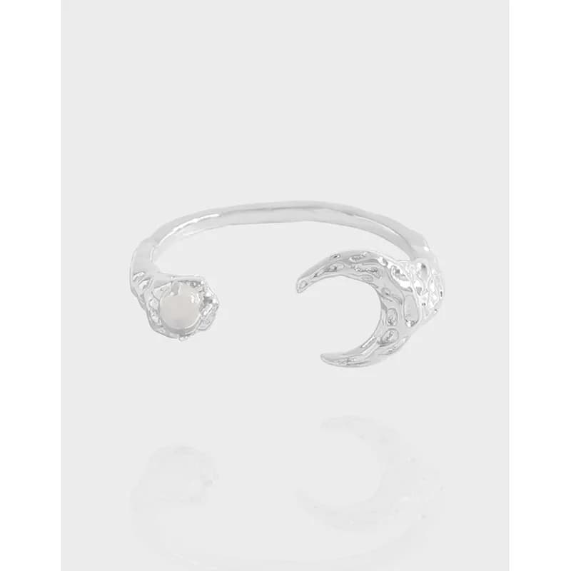 Open silver ring with a pearl-set end and a claw-shaped textured other end