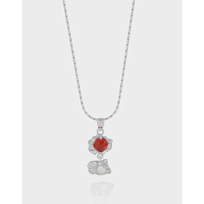 Polished Sterling Silver necklace with red bead pendant and leaf-inspired charms