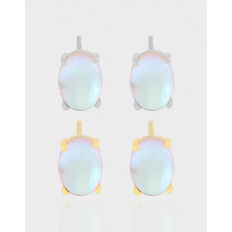 Group of four oval iridescent stud earrings in silver and gold-tone settings.