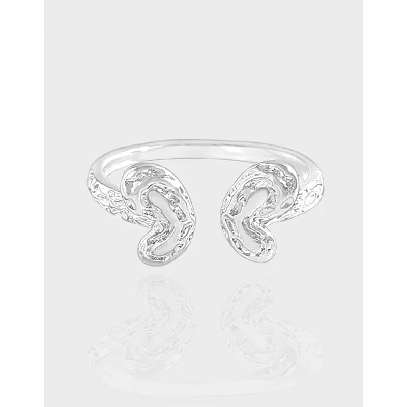 Polished sterling silver open ring with two mirrored paisley-inspired loops on a white background.