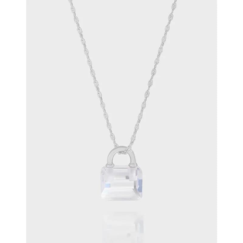 Sterling silver necklace with a faceted clear crystal lock pendant on a delicate chain.