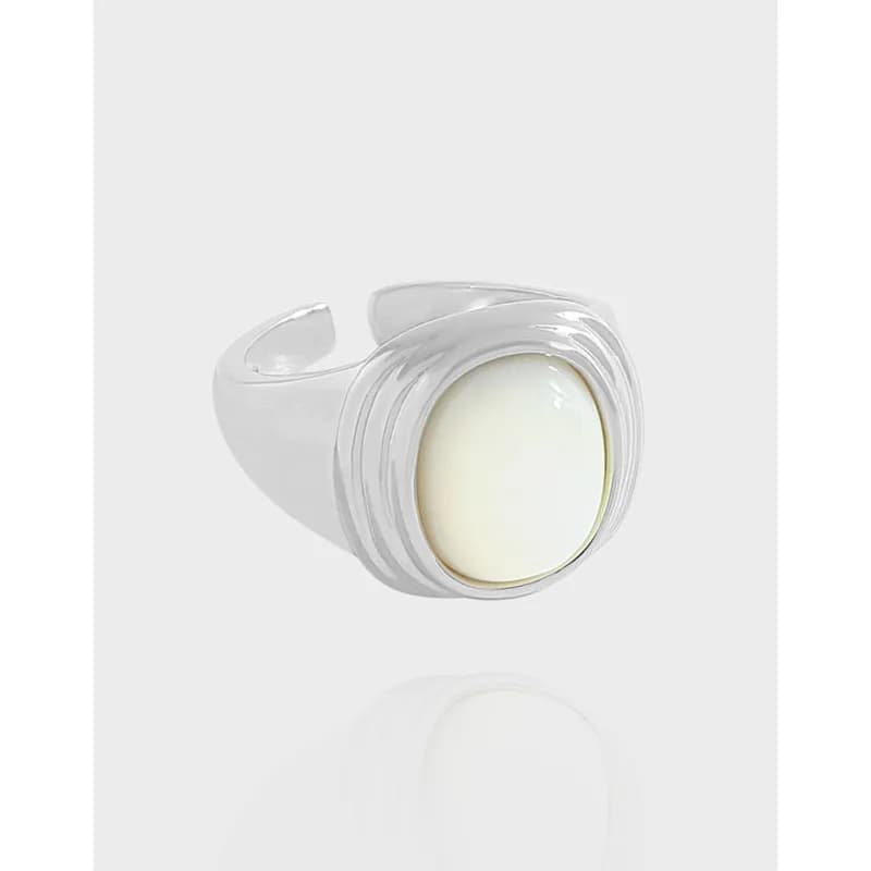 Polished Sterling Silver Ring with an oval cream cabochon set in a layered bezel design.