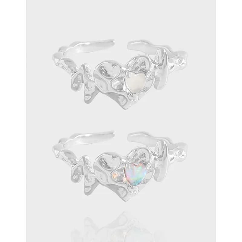 Two polished sterling silver rings with an organic heart-cluster design displayed on a white background.