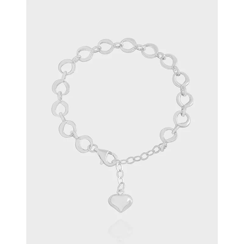 Polished sterling silver circle-link bracelet with a heart charm hanging from an extender chain.