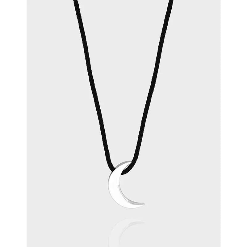 Polished sterling silver crescent pendant on a black cord necklace