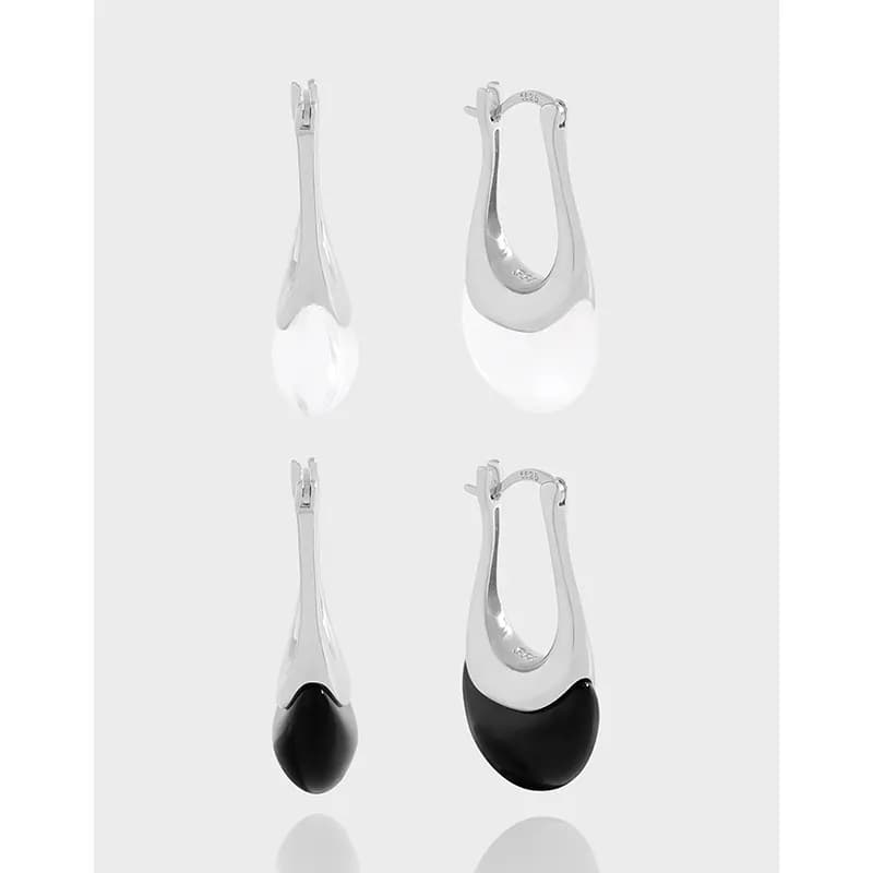 Polished sterling silver teardrop shield earrings with open upper section and rounded bottom disc.