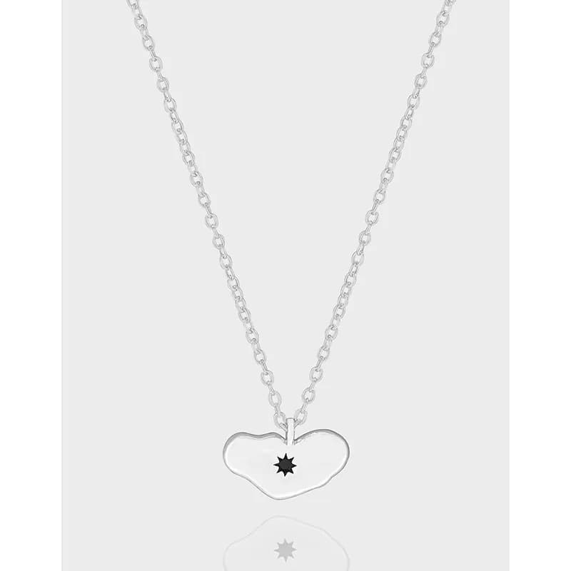 Sterling silver heart pendant necklace with a star-cut center on a polished chain