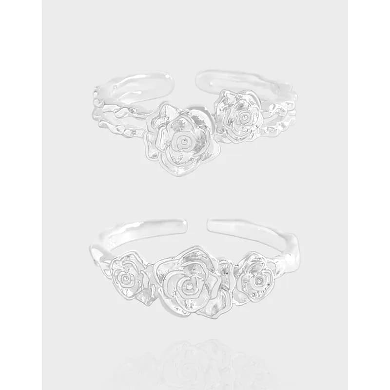 Open-ended sterling silver ring with three rose blooms along the top of the band.
