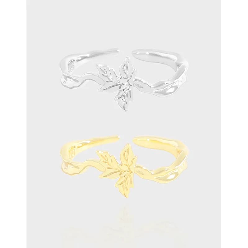 Open-leaf motif ring with a vine-like band in silver and a gold-tone version shown side by side.
