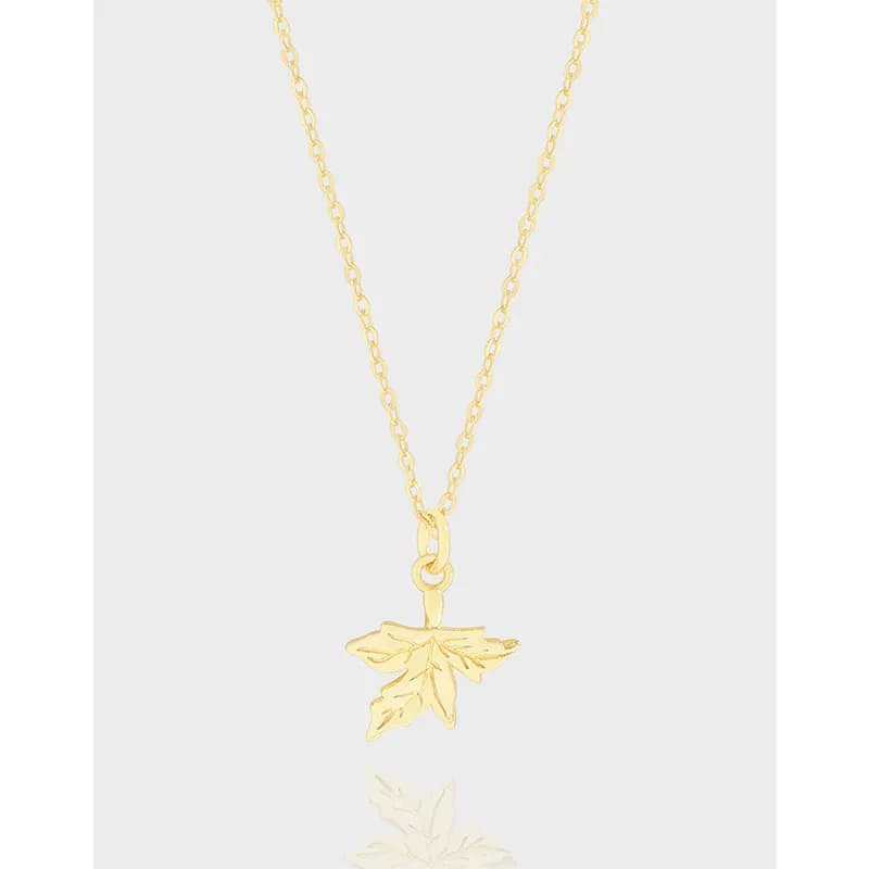Polished sterling silver maple leaf pendant on a fine chain against a light background.