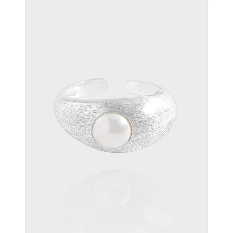 Brushed silver ring with a single pearl centerpiece on an open-band