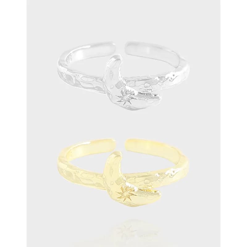 Silver and gold crescent moon rings with hammered bands and delicate star engraving on the moon