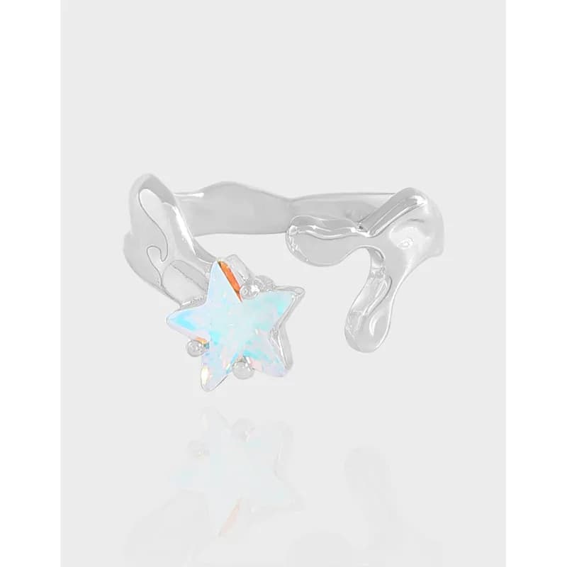 Close-up of a polished silver ring with an iridescent star gemstone centerpiece