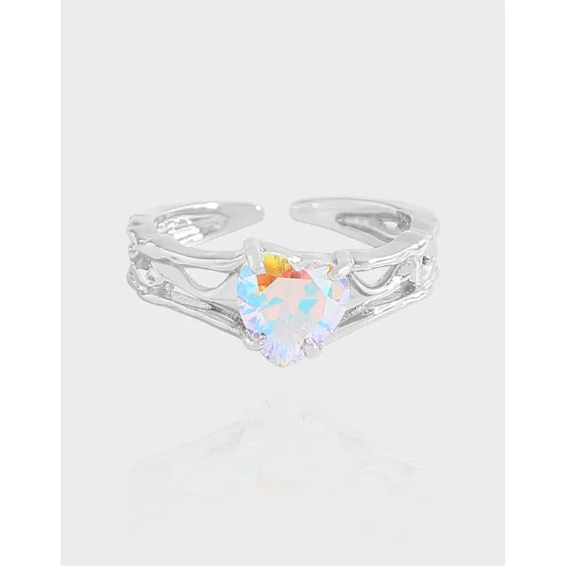 Sterling silver ring with a rainbow iridescent heart-cut crystal centerpiece on a split, openwork band.