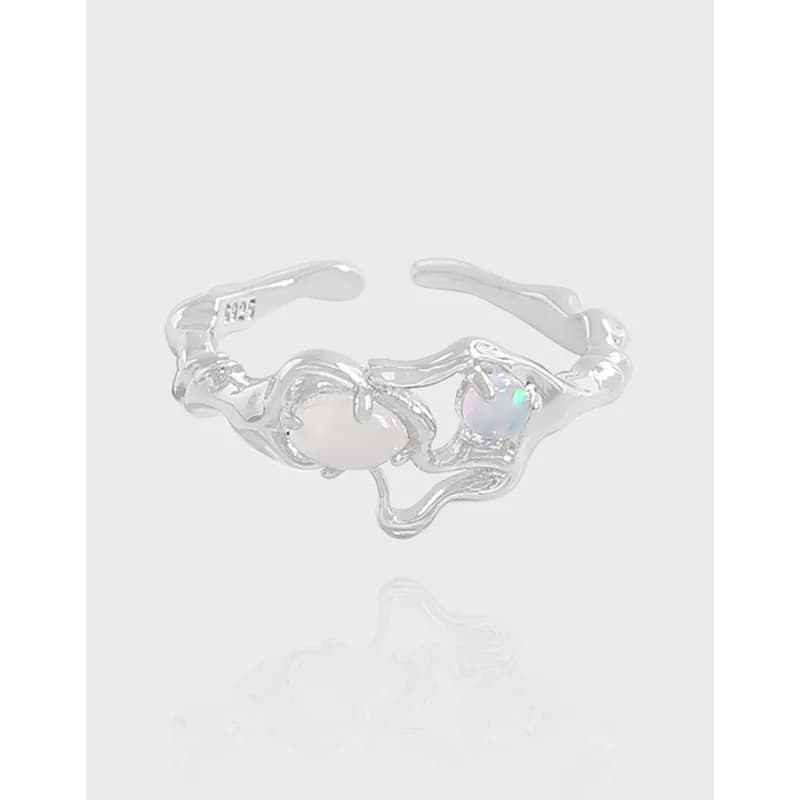 Open sterling silver ring with a wavy band and two bezel-set stones (pearl-like and opal)