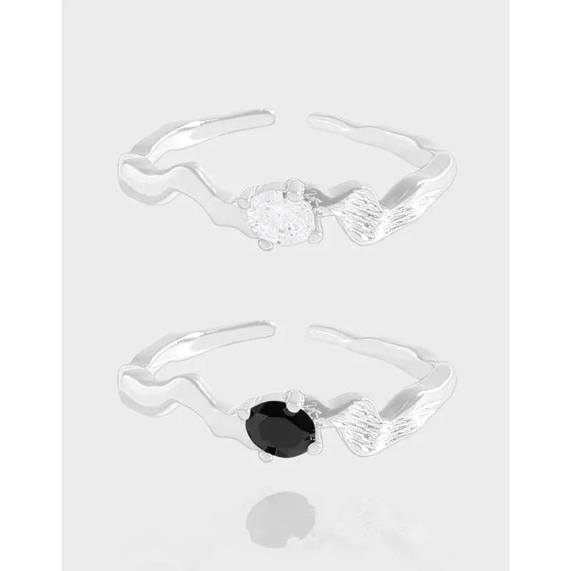 Polished sterling silver ring with a wavy band and a central round gemstone in two color options.