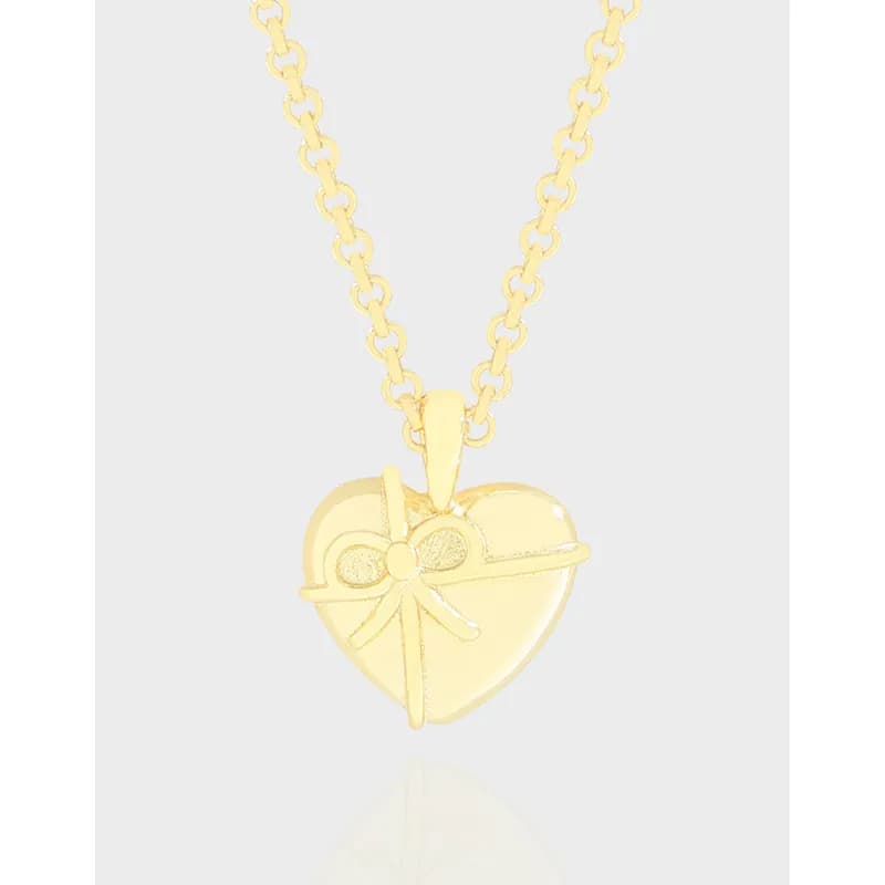 Polished silver heart pendant with a bow on a delicate chain
