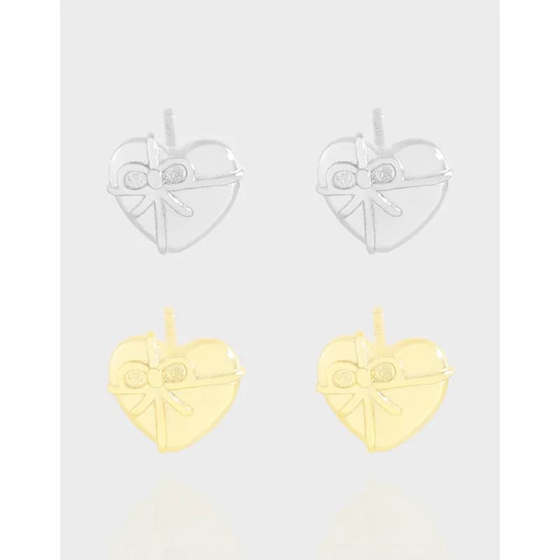 Polished sterling silver heart-shaped earrings with a bow detail, shown from the front.