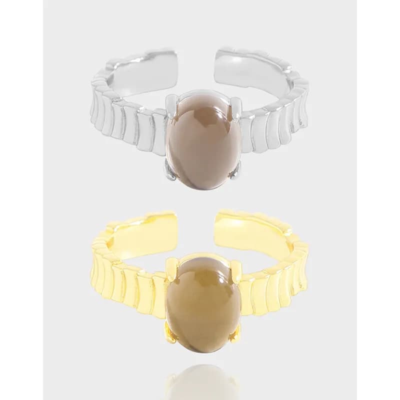 Polished silver oval cabochon ring with a ribbed segmented band and four-prong setting