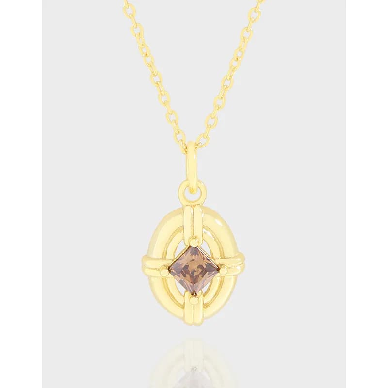 Gold-tone circular halo pendant with square lilac gemstone on a delicate chain