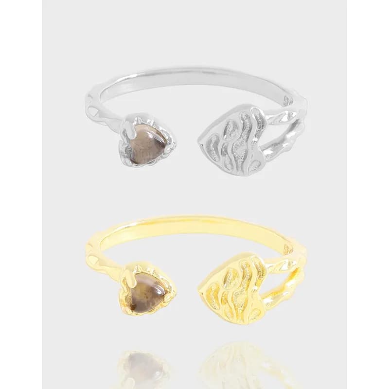 Polished sterling silver open-ring with a brown cabochon on one end and a textured leaf motif on the other.