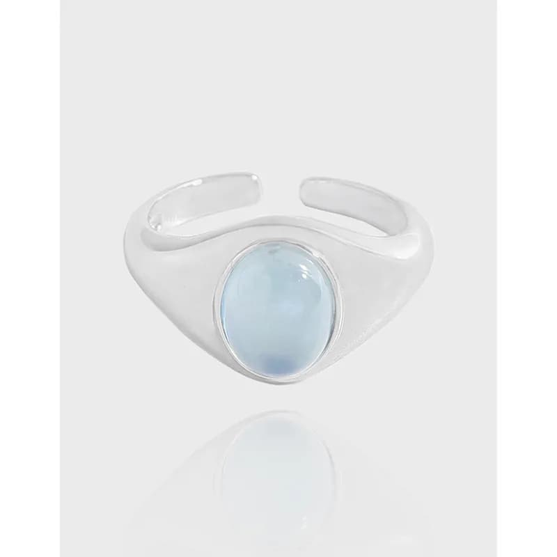 Polished sterling silver ring with an oval light blue cabochon bezel setting