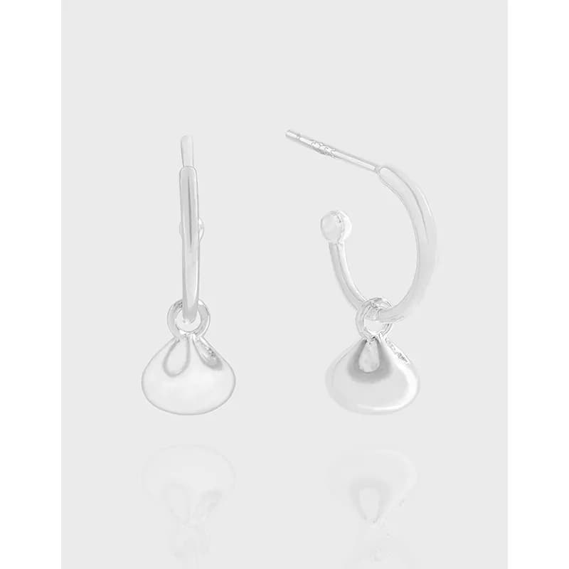 Polished sterling silver hoop earrings with a small teardrop charm hanging from a ring