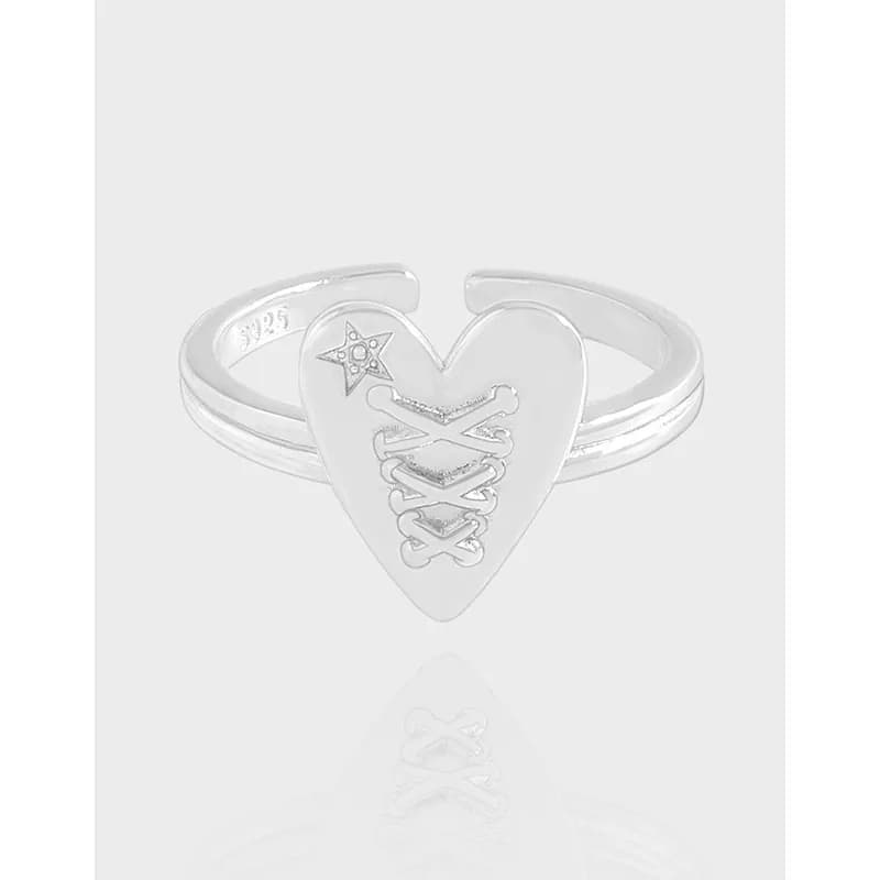 Polished silver heart-shaped ring with a lace-like lattice detail on the front.