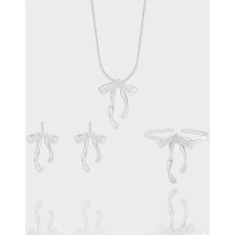 Polished sterling silver dragonfly pendant on a chain with matching dragonfly earrings and a dragonfly ring.