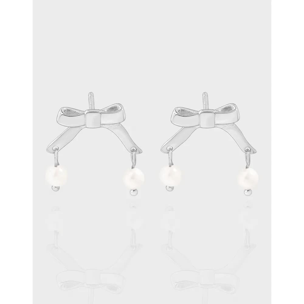 Pair of polished sterling silver bow earrings with dangling pearl drops