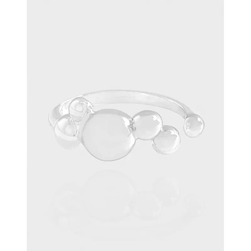 Polished sterling silver ring with a row of varying-size bubble beads along the top.