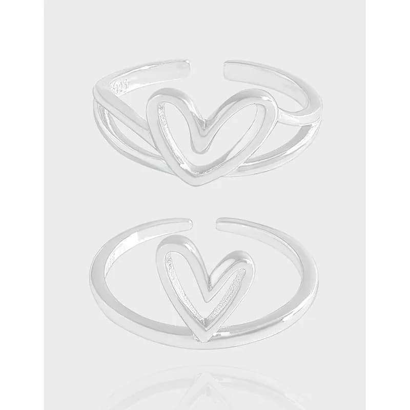 Polished sterling silver open-heart ring displayed against a light background.