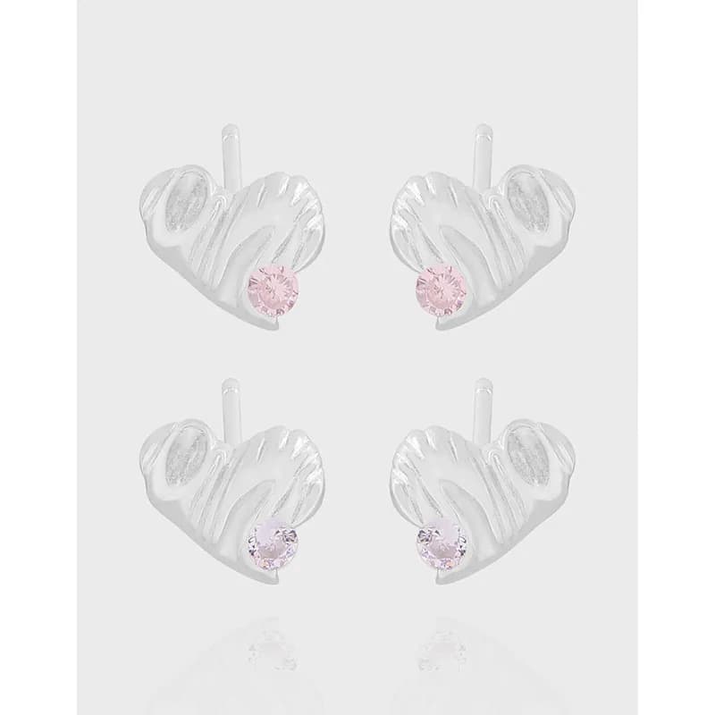 Four polished sterling silver heart-shaped stud earrings with pink crystals on the bottom.