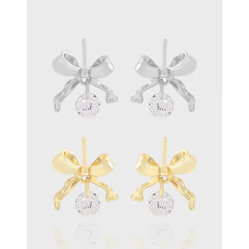 Silver and gold-tone Bow Dangle Earrings with crystal drops displayed side by side.