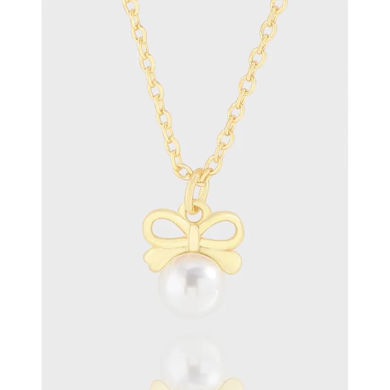 Polished sterling silver necklace with a bow-shaped charm and pearl pendant