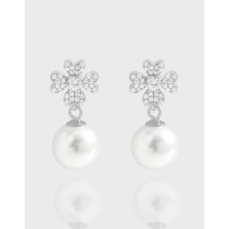 Polished sterling silver Clover Pavé Pearl Earrings with crystal-encrusted four-leaf top and dangling pearl drops.