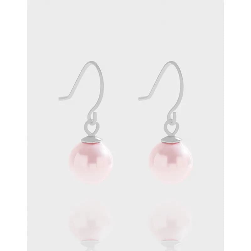 Pair of pink pearl drop earrings with sterling silver hooks and caps