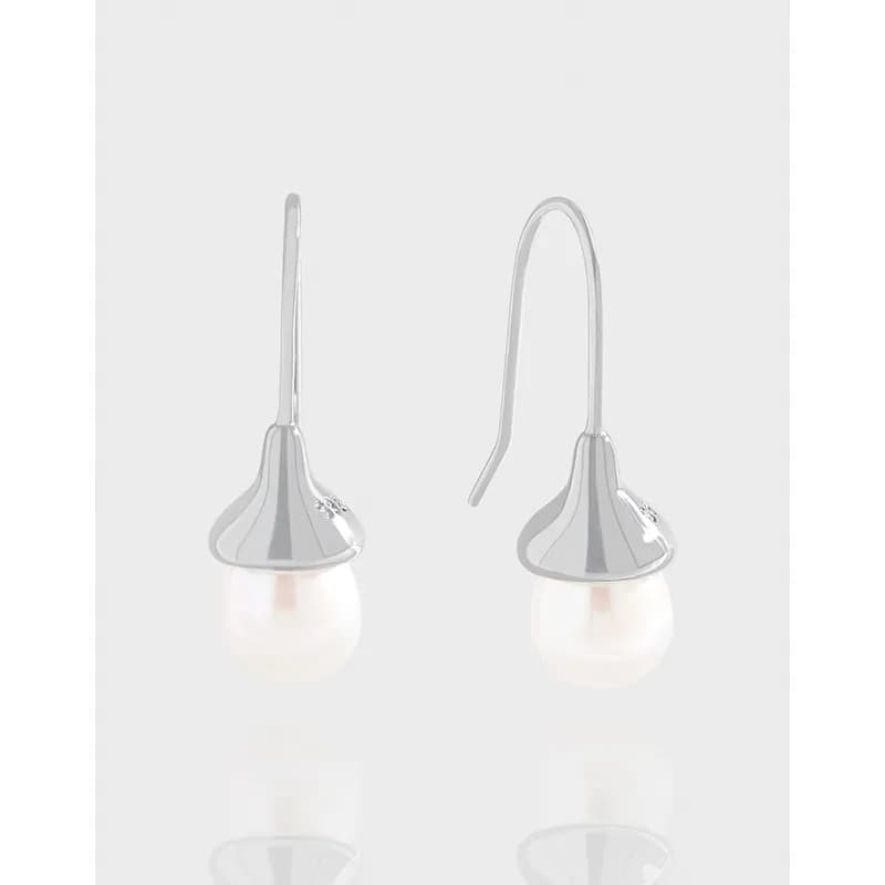 Polished sterling silver drop earrings with a flared cap and hanging white pearl