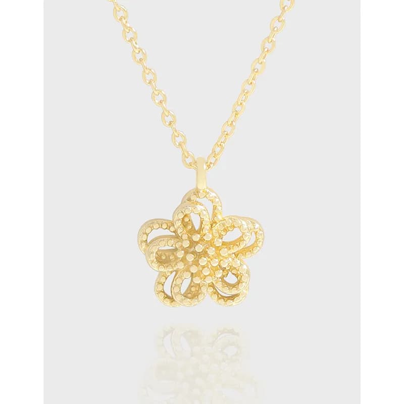 Sterling silver flower pendant on a delicate chain necklace with a polished finish.