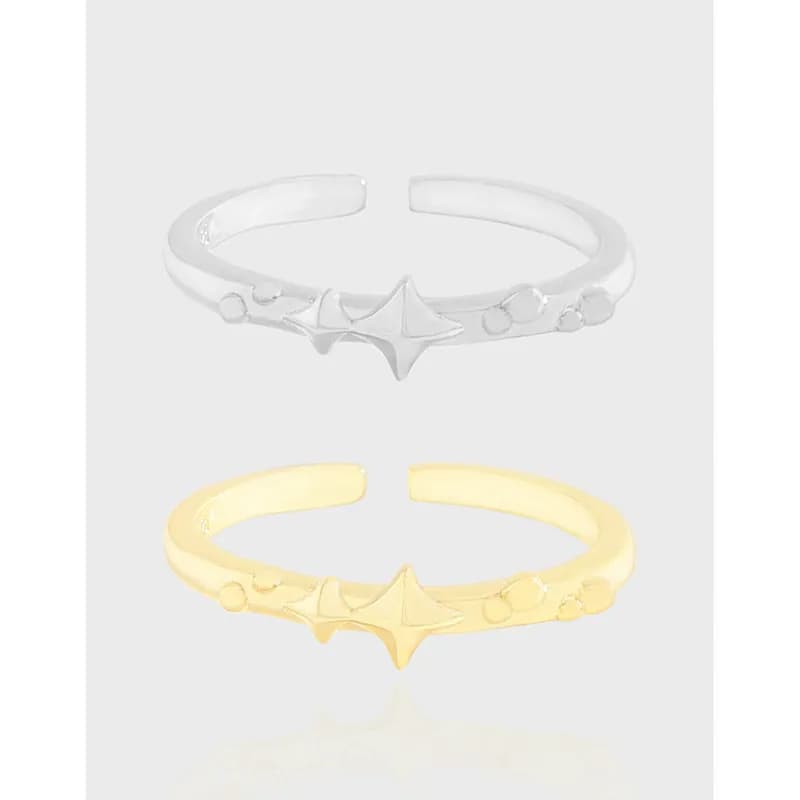 Polished sterling silver open-band ring with a central angular star and small bead accents along the band.